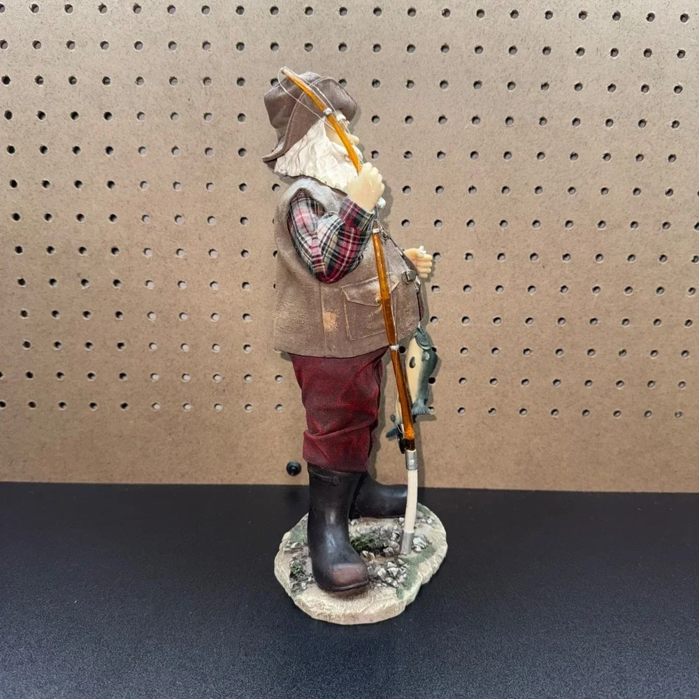 Christmas 2005 Santa fishing figurine holding a fishing pole and fish plastic